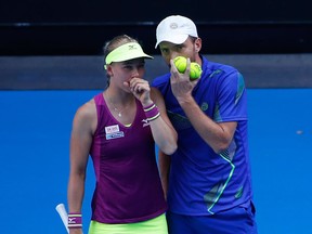 Johanna Larsson of Sweden and Matwe Middelkoop of the Netherlands talk tactics in their mixed doubles quarter-final match against Gabriela Dabrowski of Canada and Mate Pavic of Croatia on day 11 of the 2018 Australian Open at Melbourne Park on January 25, 2018 in Melbourne, Australia. (Photo by Darrian Traynor/Getty Images)