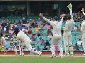 Moeen Ali (left) lines out to Nathan Lyon during the Fifth Test match in the 
Ashes Series between Australia and England at Sydney Cricket Ground in Australia on Monday. (AP)