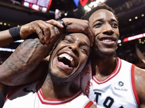 Toronto Raptors' Kyle Lowry, left, and DeMar DeRozan celebrate after defeating the Milwaukee Bucks in NBA basketball action in Toronto on Monday, January 1, 2018. THE CANADIAN PRESS/Frank Gunn