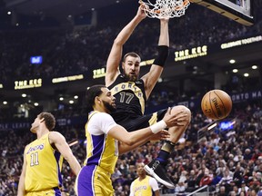 Toronto Raptors centre Jonas Valanciunas dunks as Los Angeles Lakers guard Tyler Ennis, of Brampton, looks on during first half NBA basketball action in Toronto on Sunday, January 28, 2018. THE CANADIAN PRESS