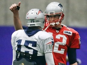 New England Patriots quarterback Tom Brady (12) talks with wide receiver Chris Hogan (15) during a practice Wednesday, Jan. 31, 2018, in Minneapolis. (AP Photo/Mark Humphrey)