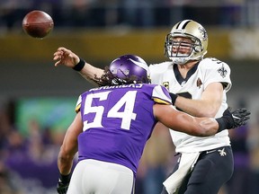 Drew Brees of the New Orleans Saints throws a pass under pressure from Eric Kendricks of the Minnesota Vikings during the NFC Divisional Playoff game at U.S. Bank Stadium on January 14, 2018 in Minneapolis. (Jamie Squire/Getty Images)