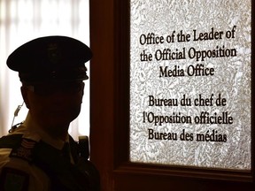 A security guard stands near Patrick Brown's office door is shown at Queen's Park after he stepped down as leader of the Ontario Progressive Conservative party in Toronto on Thursday Jan. 25, 2018. Brown stepped down overnight, hours after holding a news conference to deny what he called "troubling allegations'' that he didn't detail.