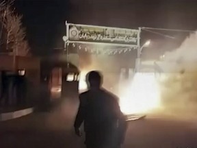 This frame grab from video was taken by an individual not employed by the Associated Press and obtained by the AP outside Iran from FreedomMessenger, that describes itself as an "independent Iranian news agency seeking complete change of the Iranian regime by reporting on the human rights situation in Iran," purports to show attack on Iran police station in Qahdarijan, Iran, Tuesday, Jan. 2, 2018. (FreedomMessenger via AP)