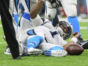 Carolina Panthers quarterback Cam Newton lies on the field after being sacked during an NFL NFC wild-card playoff football game against the New Orleans Saints on Sunday, Jan. 7, 2018 in New Orleans.  (Scott Clause/The Daily Advertiser via AP)