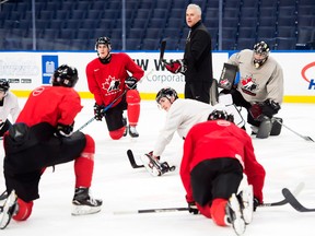 Team Canada head coach Dominique Ducharme talks with his players at the end of practice in Buffalo on Jan. 3, 2018