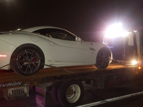 A Ferrari is towed after Halton cops nabbed a couple of cars drag racing in Norval on Friday, Jan. 26, 2018.