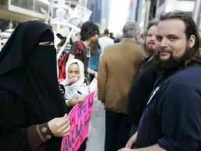 Zaynab Khadr, left, and husband Joshua Boyle protest in front of the Metro Convention centre in Toronto on Friday May 29, 2009. THE CANADIAN PRESS/Jim Ross
