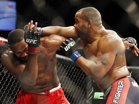 Daniel Cormier hits Jon Jones during their light heavyweight title bout at UFC 182, Saturday, Jan. 3, 2015, in Las Vegas. (AP Photo/John Locher)