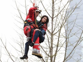 A woman is rescued from a downtown Toronto crane early Wednesday, April 26, 2017.  THE CANADIAN PRESS/Frank Gunn