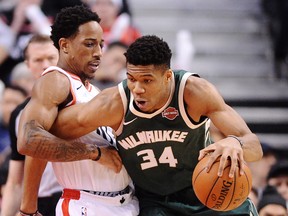Raptors guard DeMar DeRozan (left) defends against Milwaukee Bucks forward Giannis Antetokounmpo on Monday night at the Air Canada Centre. (THE CANADIAN PRESS)