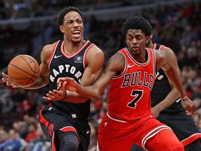 DeMar DeRozan of the Toronto Raptors drives against Justin Holiday of the Chicago Bulls at the United Center on January 3, 2018 in Chicago.