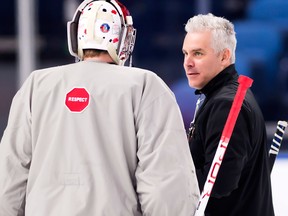 Team Canada goalie Carter Hart talks with head coach Dominique Ducharme during practice in Buffalo on Jan. 3, 2018