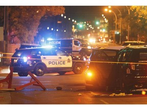 Police investigate the scene where a car crashed into a roadblock in Edmonton on September 30, 2017.