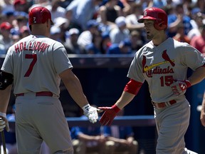 St. Louis Cardinals Randal Grichuk (right) is congratulated by teammate Matt Holliday after hitting a solo homer during interleague action in Toronto on Saturday June 7, 2014. (THE CANADIAN PRESS/Frank Gunn)