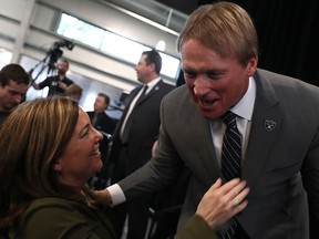 Oakland Raiders new head coach Jon Gruden greets San Francisco Chronicle sports reporter Ann Killion during a news conference at Oakland Raiders headquarters on Jan. 9, 2018