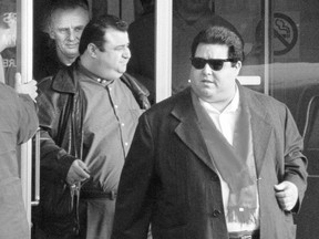 Pat Musitano, right, and his late brother Angelo, behind him, leave a Hamilton court in January 1998.