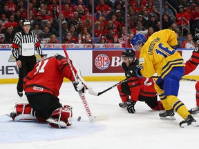 Canada goalie Carter Hart makes a save on Sweden’s Linus Lindstrom during the gold-medal game on Friday night in Buffalo. (Getty Images)