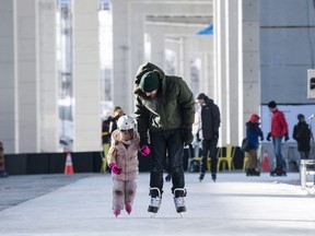 Gerald Alvoed and Sienna Alvoed (4) skate in a media preview of the Bentway Skate Trail, a 220 metre ribbon of ice running under a section of the Gardiner Expressway, in Toronto, on Friday, January 5, 2018. THE CANADIAN PRESS/Christopher Katsarov