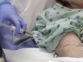 A hospital patient receives a flu shot.
