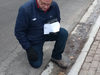 Toronto Police Det. Martin Woodhouse seizes two earrings at the end of the Sherman driveway on Jan. 27, 2018.