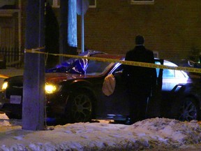 Toronto Police examine a car after four men were shot early Friday, Jan. 19, 2018 at the corner of West Dean Park and Rabbit Lane. (Pascal Marchand photo)