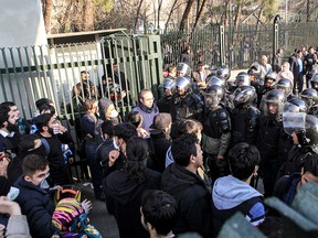 In this Dec. 30, 2017 file photo taken by an individual not employed by the Associated Press and obtained by the AP outside Iran, anti-riot Iranian police prevent university students to join other protesters over Iran weak economy, in Tehran, Iran.  (AP Photo, File)