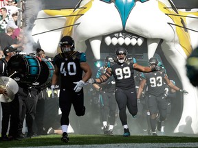 Jacksonville Jaguars defensive tackle Eli Ankou reacts as he and teammates run onto the field before an NFL game on Sept. 24, 2017