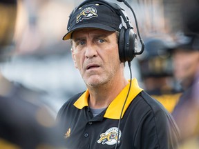 Hamilton Tiger-Cats head coach Kent Austin watches a play develop against the Winnipeg Blue Bombers on Aug. 12, 2017