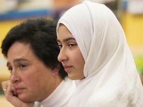 An emotional Khawlah Noman, 11, is accompanied by TDSB spokesman Shari Schwartz-Maltz, recalls a man slicing her hijab with scissors as she and her brother Mohammad Zakarijja walked to Pauline Johnson Public School in Scarborough on Friday, Jan. 12, 2018.