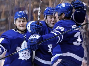 Leafs centre Auston Matthews celebrates his goal with Morgan Rielly and William Nylander Saturday against the Vancouver Canucksat the Air Canada Centre.