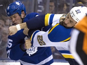 Toronto Maple Leafs' Matt Martin (15) gets roughed by St. Louis Blues right winger Chris Thorburn at the Air Canada Centre in Toronto on Tuesday, January 16, 2018. (Stan Behal/Toronto Sun)