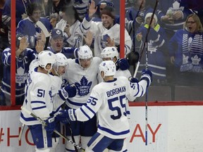 Toronto Maple Leafs fans look on as Leafs players (left to right) Jake Gardiner, Zach Hyman, Auston Matthews, Andreas Borgman and William Nylander celebrate a goal by Matthews (34) against the Ottawa Senators during third period NHL action in Ottawa, Saturday, Jan.20, 2018. THE CANADIAN PRESS/Adrian Wyld