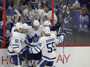Toronto Maple Leafs fans look on as Leafs players (left to right) Jake Gardiner, Zach Hyman, Auston Matthews, Andreas Borgman and William Nylander celebrate a goal by Matthews (34) against the Ottawa Senators during third period NHL action in Ottawa, Saturday, Jan.20, 2018. THE CANADIAN PRESS/Adrian Wyld ORG XMIT: AJW504