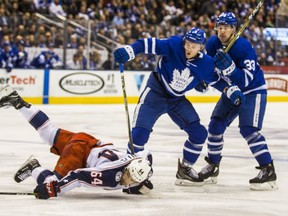 Toronto Maple Leafs Travis Dermott and Frederik Gauthier (right) during 2nd period action against the Columbus Blue Jackets Tyler Motte at the Air Canada Centre in Toronto on Monday January 8, 2018. Ernest Doroszuk/Toronto Sun