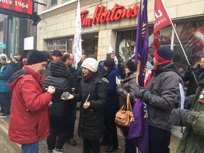 Protesters fill the street outside the Tim Hortons restaurant at Dundas and Richmond streets,  in London. NORM DEBONO/POSTMEDIA NETWORK
