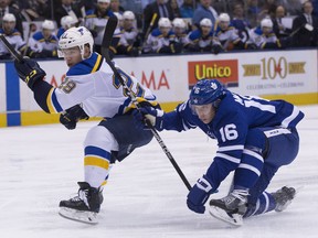 St. Louis Blues defenceman Vince Dunn and Leafs centre Mitch Marner chase the puck at the ACC last night. Leafs coach Mike Babcock says Marner has improved from his rookie season.  (Stan Behal/Toronto Sun)