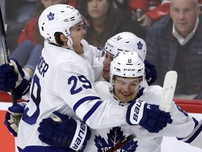 Toronto Maple Leafs center William Nylander, left, celebrates with center Auston Matthews and defenceman Connor Carrick after scoring on a penalty shot against Chicago Blackhawks goalie Jeff Glass during the overtime period in Chicago last night. (AP)