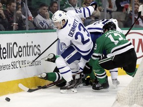 Toronto Maple Leafs defenseman Travis Dermott (23) chases after a loose puck ahead of Dallas Stars center Mattias Janmark (13) of Sweden in the first period of an NHL hockey game Thursday, Jan. 25, 2018, in Dallas.