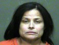 In this photo provided by the Oklahoma County Sheriff's Office, Juanita Gomez is pictured in a booking photo dated Aug. 28, 2016. Gomez is accused of killing her daughter by forcing a crucifix down her throat. (Oklahoma County Sheriff's Office via AP)