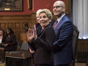 Ontario Premier Kathleen Wynne hams for the cameras as she stands next to newly appointed Minister of Economic Development and Growth, Steven Del Duca, during a swearing-in ceremony following a Cabinet Shuffle at the Ontario Legislature in Toronto on Wednesday, January 17, 2018. THE CANADIAN PRESS/Chris Young