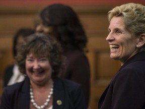 Ontario Premier Kathleen Wynne (right) stands alongside Kathryn McGarry, Ontario's new Minister for Transportation after a swearing-in ceremony following a cabinet shuffle at the Ontario Legislature In Toronto on Wednesday, January 17, 2018. THE CANADIAN PRESS/Chris Young