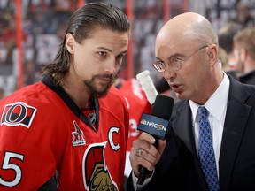 Erik Karlsson of the Ottawa Senators talks with commentator Pierre McGuire prior to a playoff game at Canadian Tire Centre on May 19, 2017