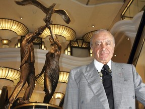 In this Sept. 1, 2005 file photo, Harrods chairman Mohamed Al Fayed unveils a new memorial statue, seen in background, on the 8th anniversary of the deaths of his son Dodi and Diana, Princess of Wales at Harrods department store in London.
