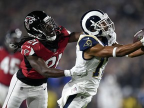 Los Angeles Rams wide receiver Robert Woods catches a pass in front of Atlanta Falcons cornerback Desmond Trufant during the NFC wild card game last night in Los Angeles. The Falcons upset the Rams 26-13. (AP)