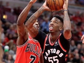 Toronto Raptors' Delon Wright drives to the basket past Chicago Bulls' Justin Holiday on Jan. 3, 2018