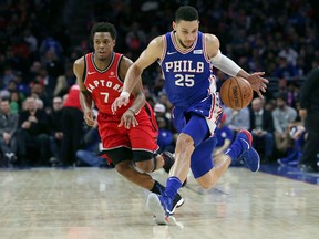 Philadelphia 76ers guard Ben Simmons loses the ball but regains possession as Toronto Raptors guard Kyle Lowry defends during the third quarter of an NBA game on Jan. 15, 2018