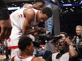 Kyle Lowry had a rough night in Brooklyn. This was one of his many tough falls, this time he got tied up with a camera man. The Associated Press