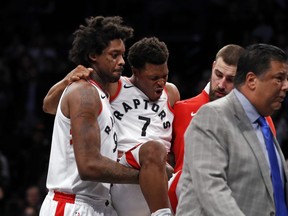 Toronto Raptors guard Kyle Lowry (7) reacts as he is carried off by teammates during the second half of an NBA basketball game against the Brooklyn Nets, Monday, Jan. 8, 2018, in New York. (AP Photo/Adam Hunger)