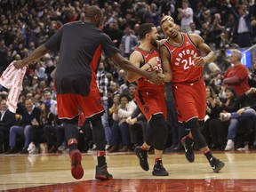 Toronto Raptors Fred VanVleet PG (23) and Serge Ibaka (L) congratulate teammate Norman Powell SF (24) after Powell drained a big 3-pointer during the fourth quarter, Raptors win 109-104  in Toronto, Ont. on Tuesday January 30, 2018. Jack Boland/Toronto Sun/Postmedia Network